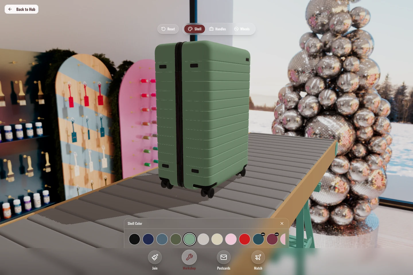 Interactive AWAY luggage customizer showing a sage suitcase in a panoramic workshop setting, with shell, handle, wheel, and color controls.